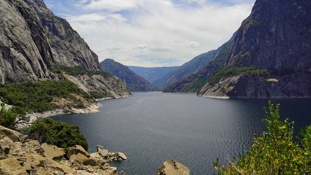 Walls of grey rock surround body of water