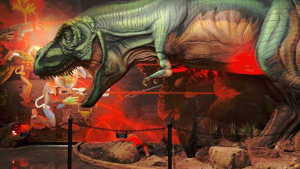 Statue of T-Rex battling a background of aliens with laser guns