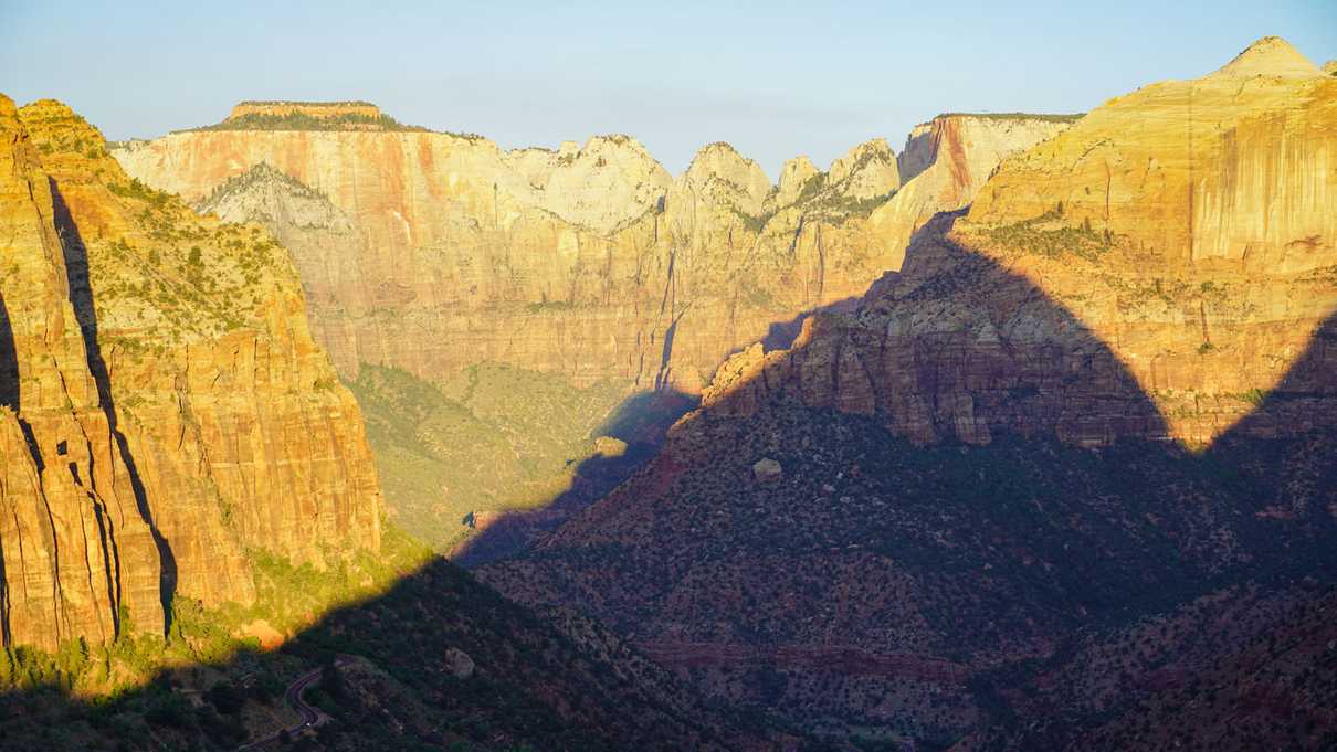 Sun illuminates canyon walls in golden light