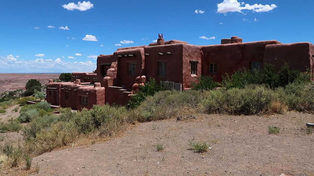 Adobe covered building overlooking desert floor below