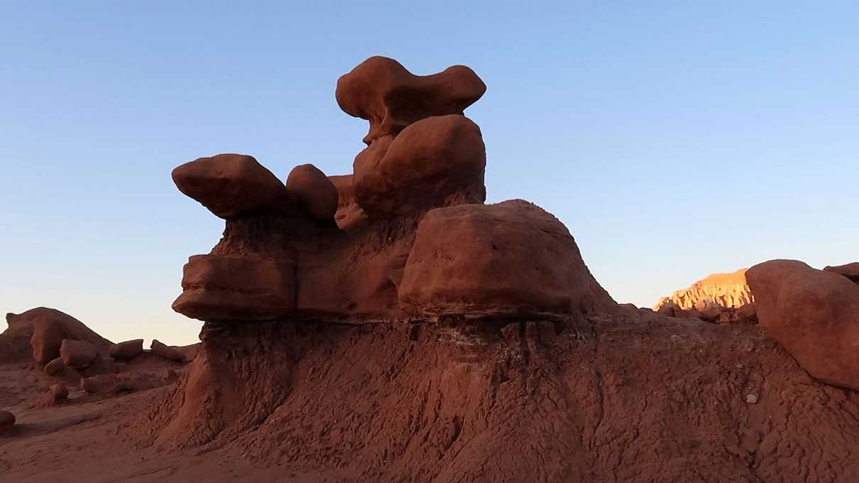 Red mushroom shaped rock spires against blue sky