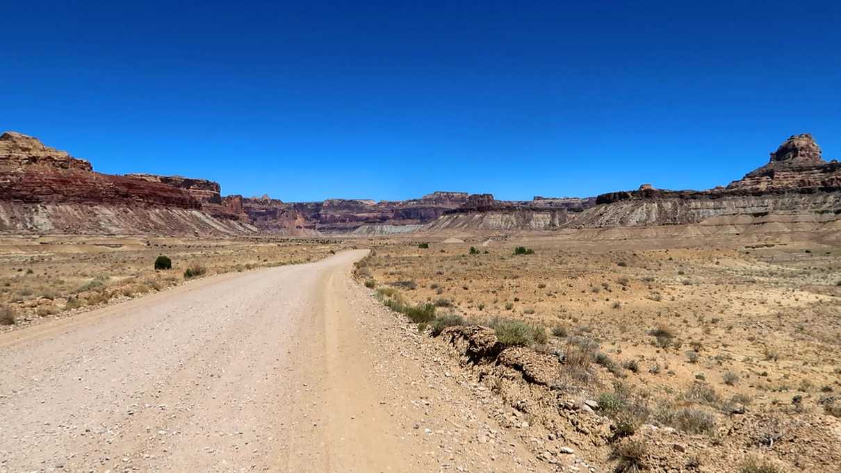 Dirt road leading off into canyon walls