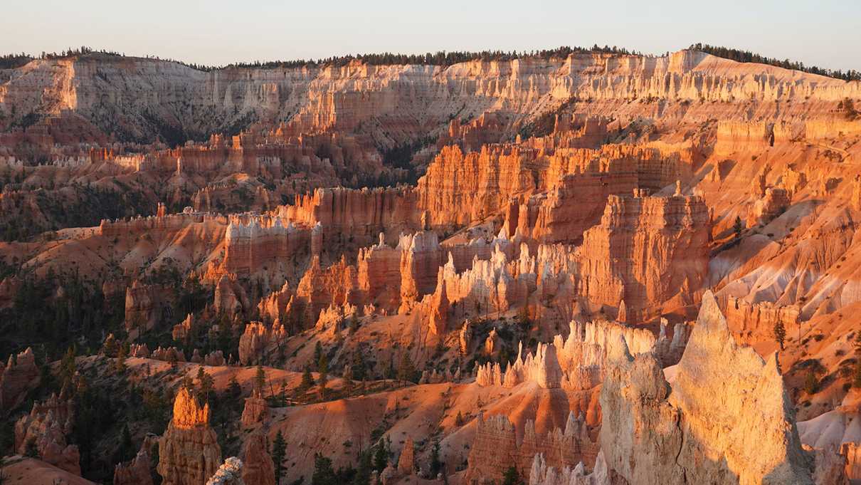 Colorful rock spires bathed in golden morning light