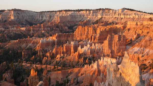 Colorful rock spires bathed in golden morning light