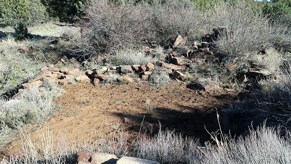 Low rock wall remains of square shaped room