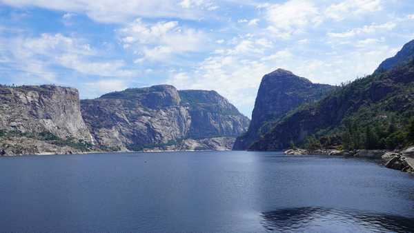 Walls of grey rock surround body of water