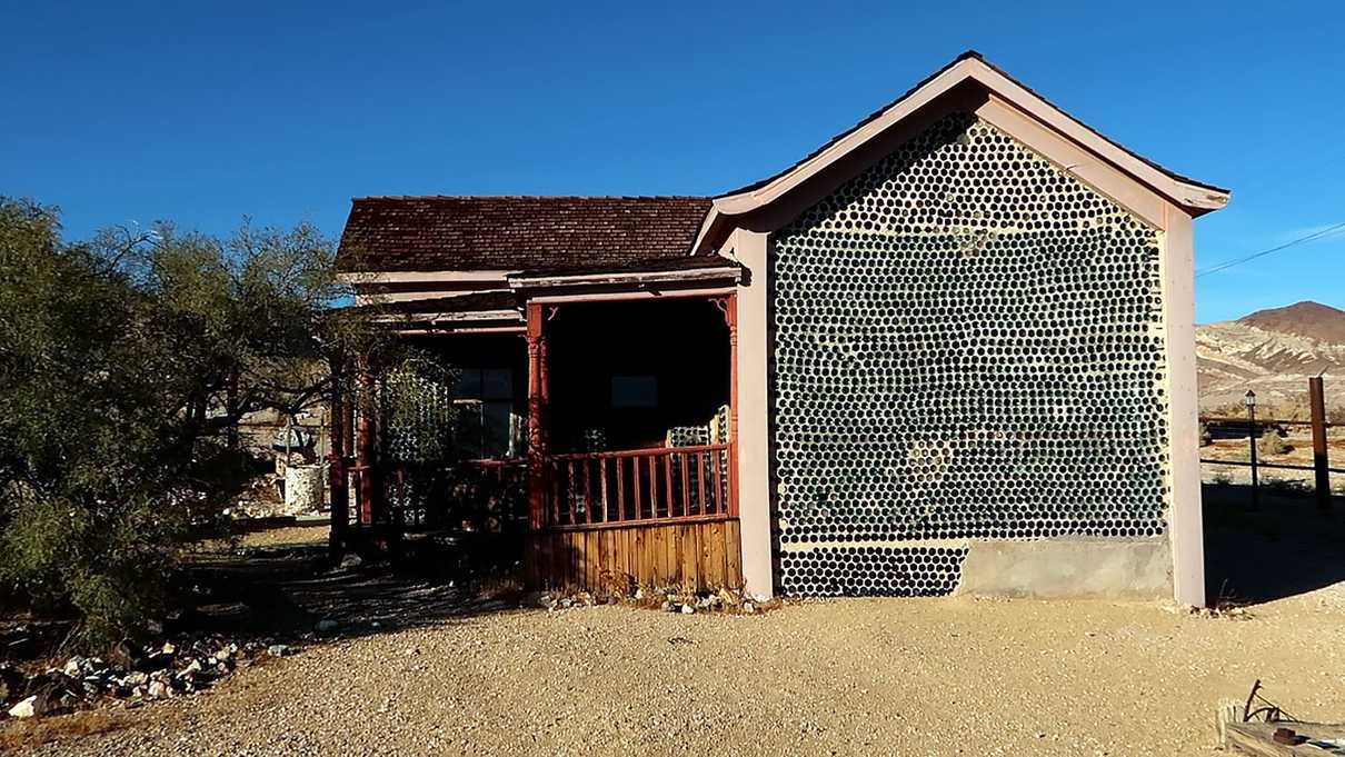 Sun shining on glass bottle house