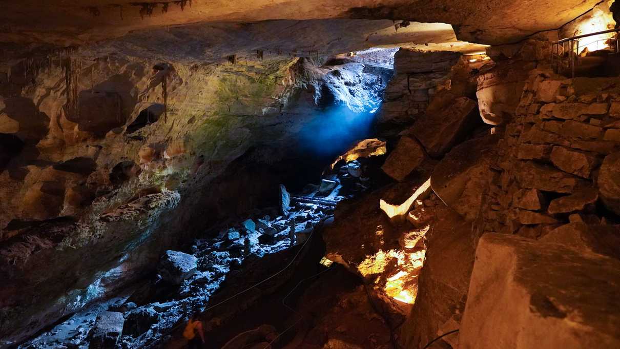 Light from cave entrance filters down onto the cavern floor