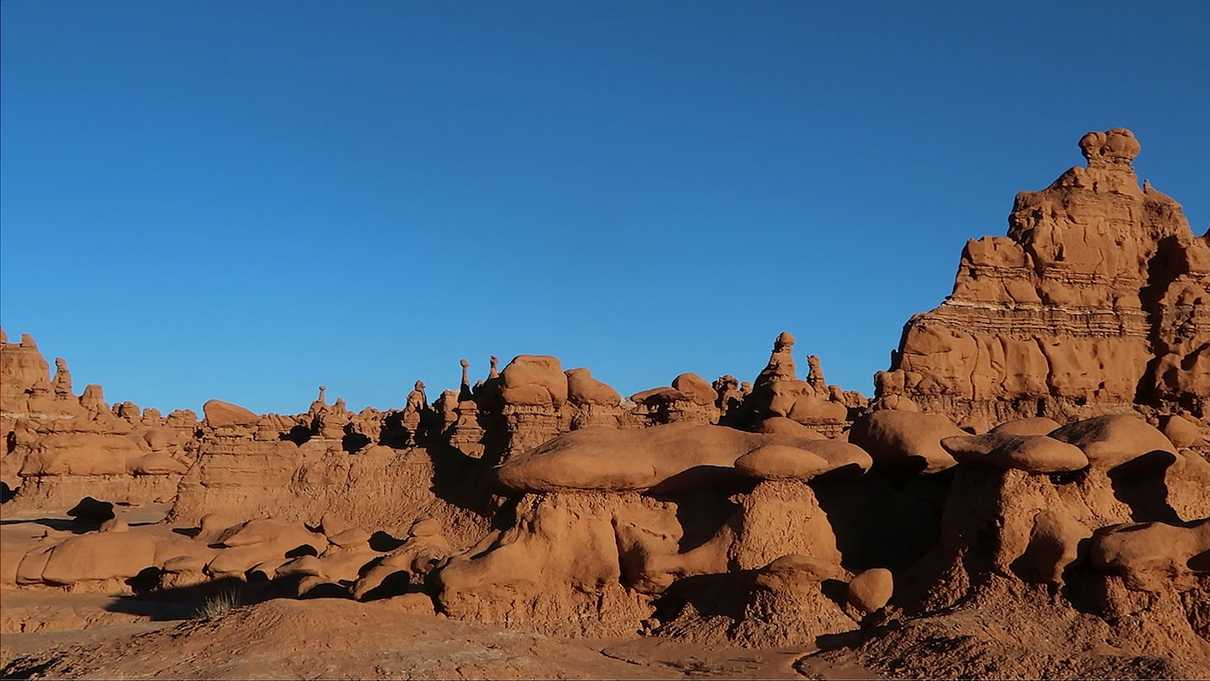 Red mushroom shaped rock spires against blue sky