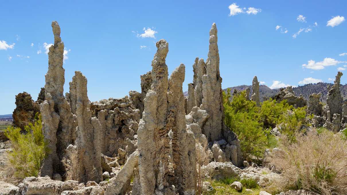 Tufa spires rise against blue sky