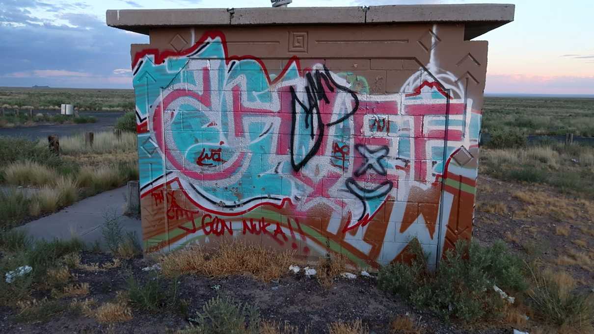 Concrete restroom facilities covered in graffiti