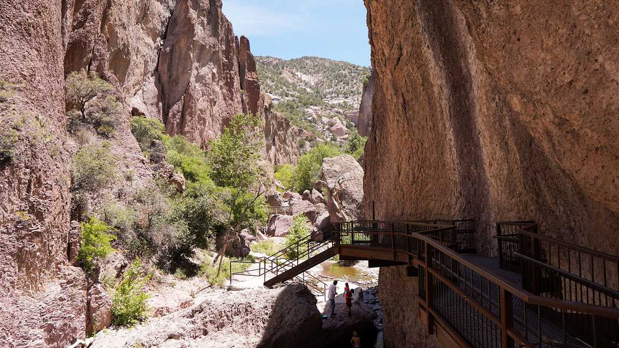 Steel catwalk leading down to creek within a canyon