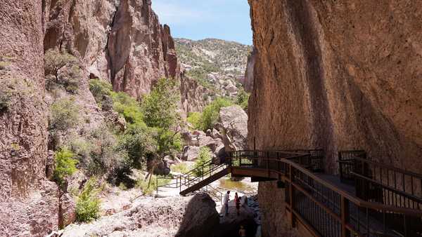 Steel catwalk leading down to creek within a canyon