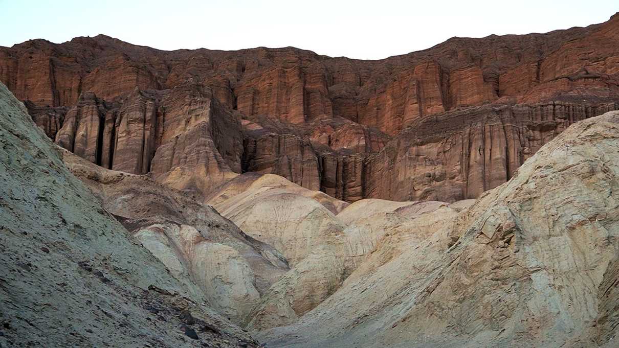 Red cliff walls atop yellow canyon walls