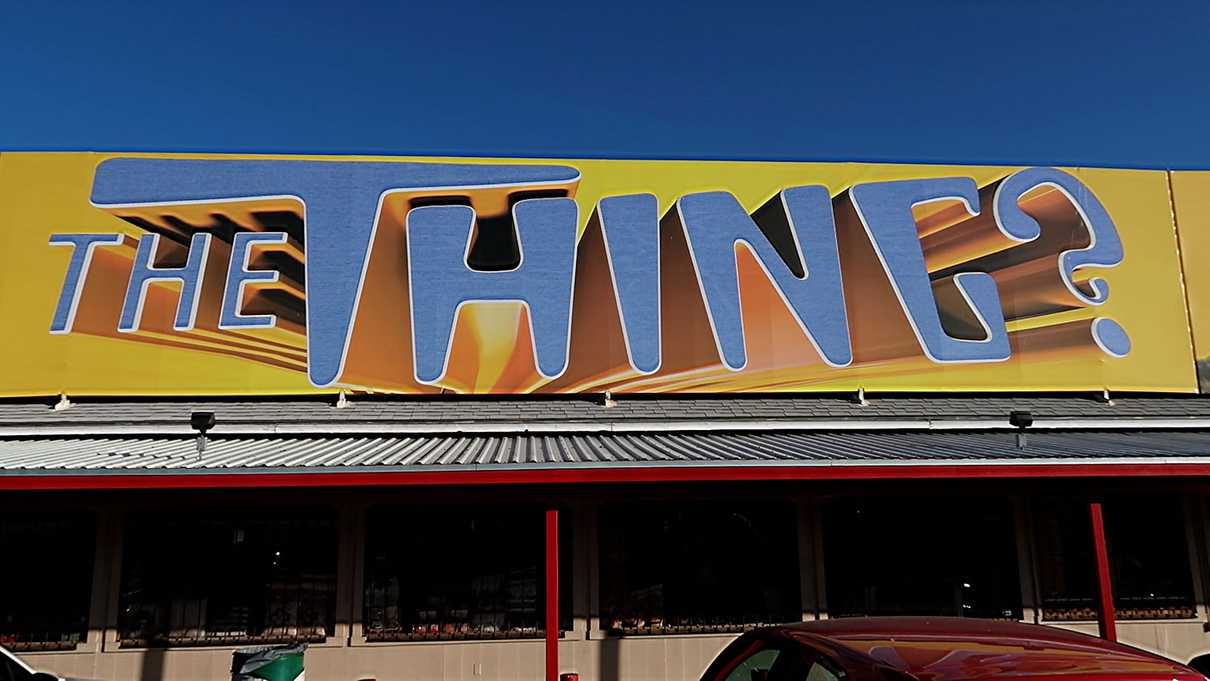 Billboard atop building advertising The Thing