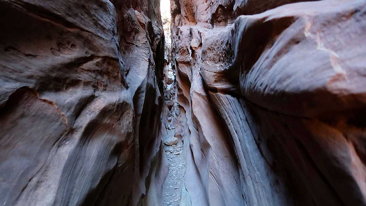 Looking down narrow slot canyon walls