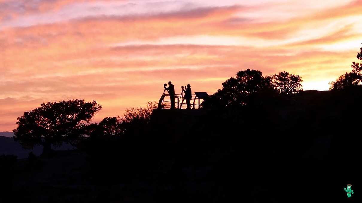 Silhouettes of people taking photos at sunset at Cape Royal