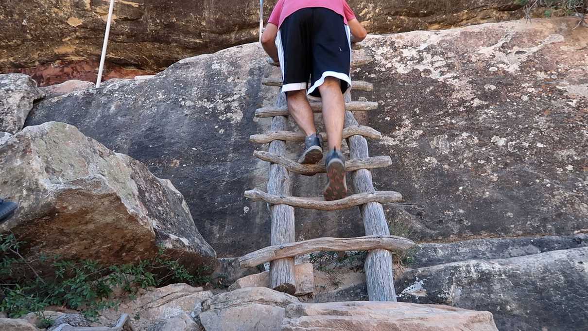 Climbing a ladder on Sipapu Trail