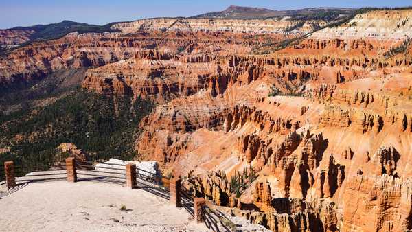 Fenced overlook with striped limestone canyon of spires below