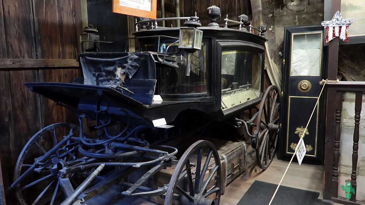 A black wooden and glass hearse called the Black Moriah