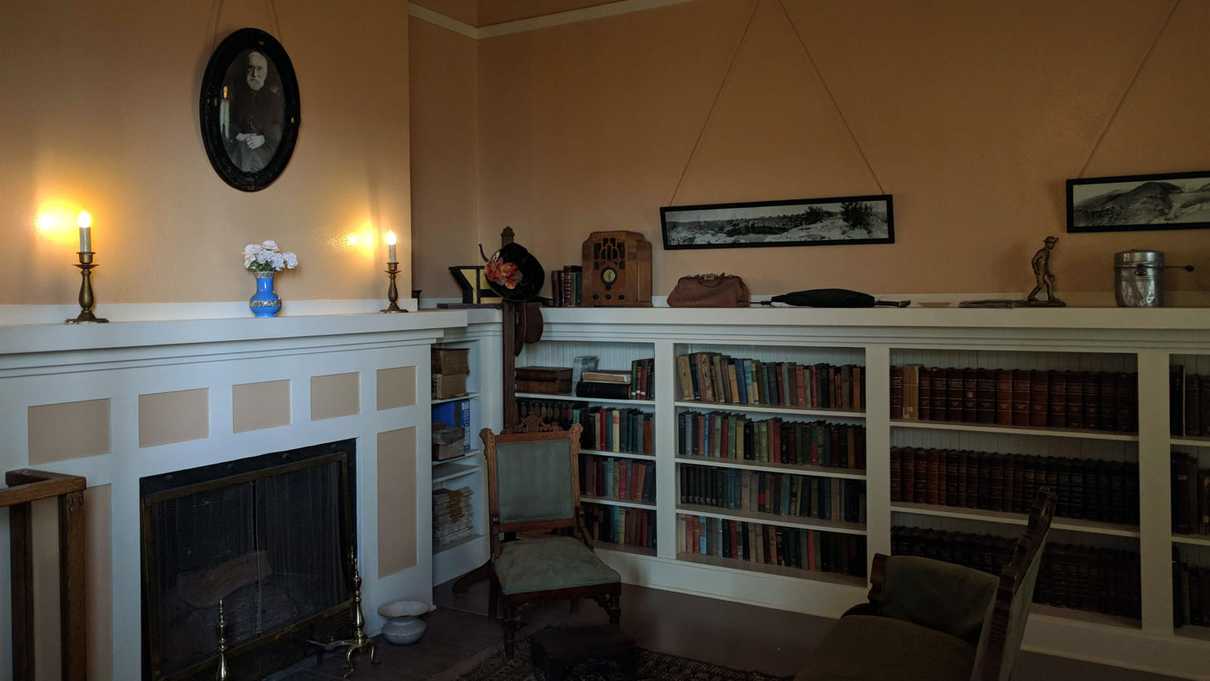 Wooden fireplace and bookcases filled with books