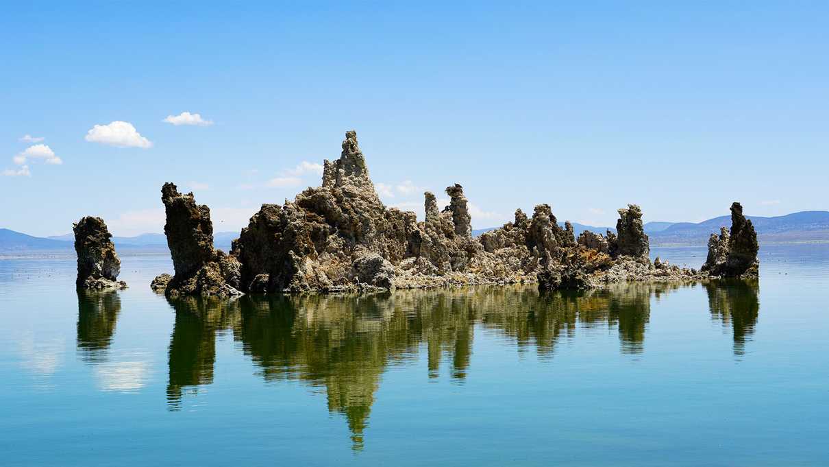 Limestone pillars rise above reflective lake surface