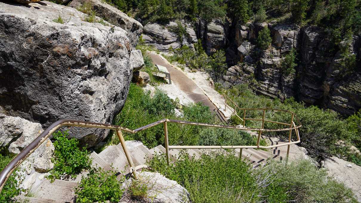 Concrete steps wind down into canyon around rocks and vegetation