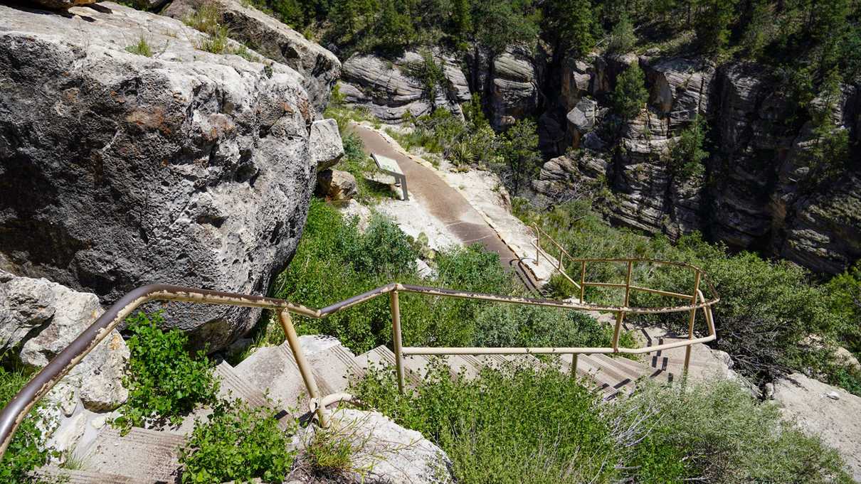 Concrete steps wind down into canyon around rocks and vegetation