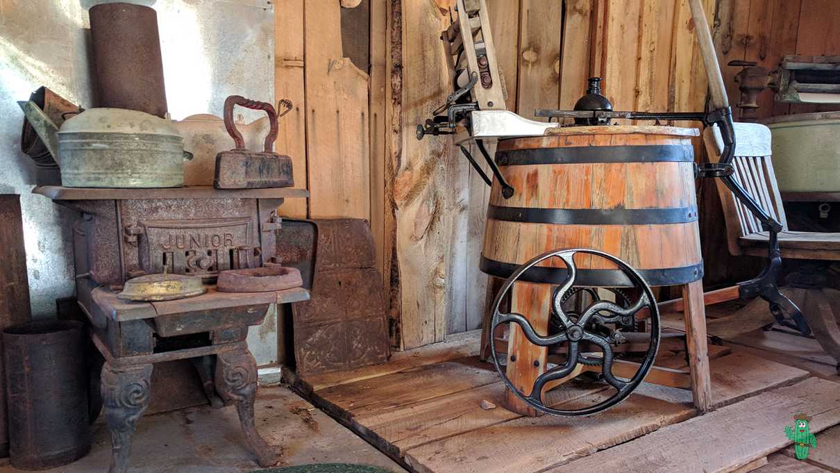 Rusted stove with various old laundry equipment