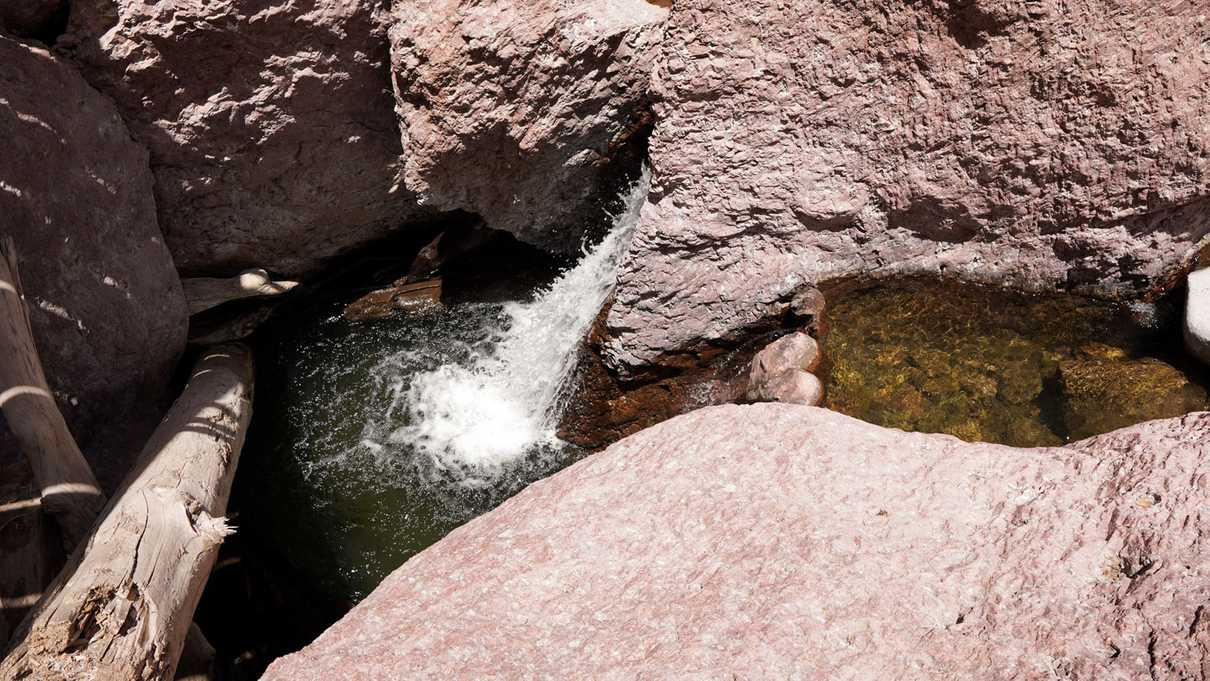 Swimming hole at the base of a small waterfall